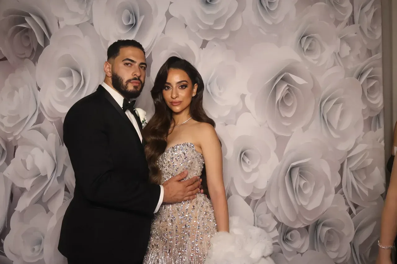 Couple celebrating at wedding reception photo booth